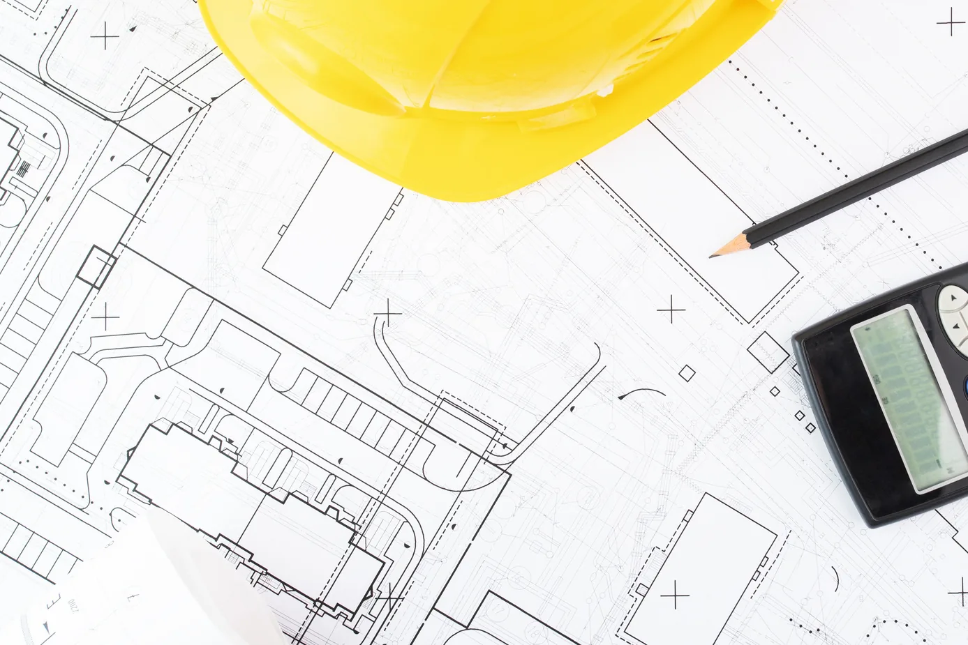 Facility drawings with an engineer’s helmet